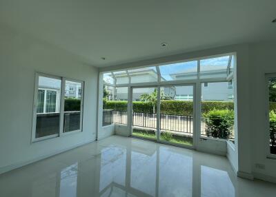 Spacious living room with large windows and natural light