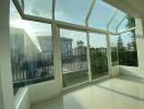 Bright sunroom with large windows and garden view