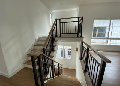 Modern staircase with wooden steps and metal railings