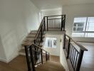 Modern staircase with wooden steps and metal railings