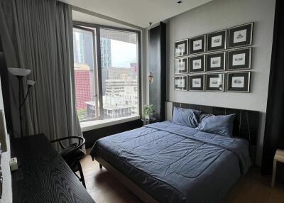 Modern bedroom with large window and city view