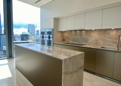 Modern kitchen with marble countertops and city view