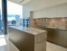 Modern kitchen with marble countertops and city view