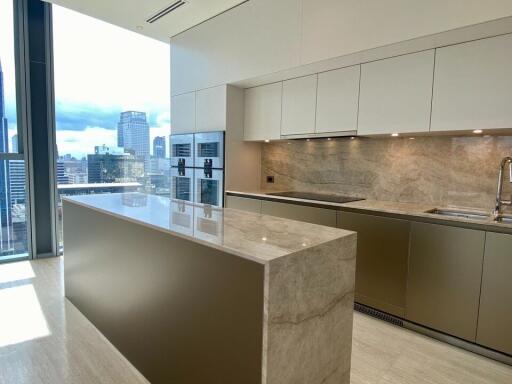 Modern kitchen with marble countertops and city view