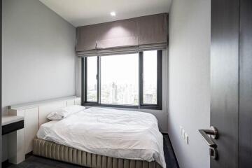 Modern bedroom with large window and city view