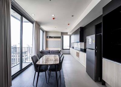 Modern kitchen and dining area with large windows and balcony