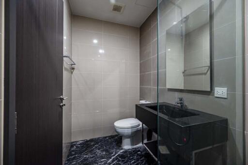 Modern bathroom with glass shower and black vanity