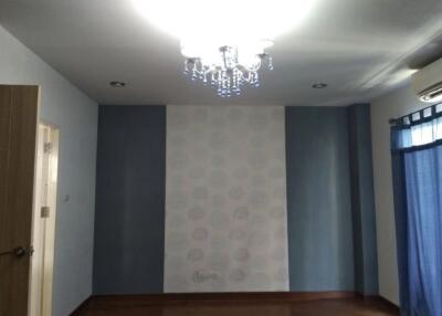 Bedroom with chandelier and patterned wallpaper