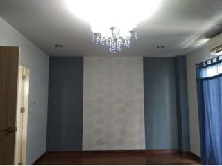 Bedroom with chandelier and patterned wallpaper