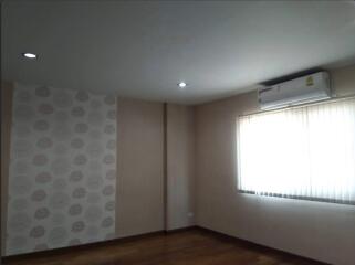 Spacious living room with a window and air conditioning unit