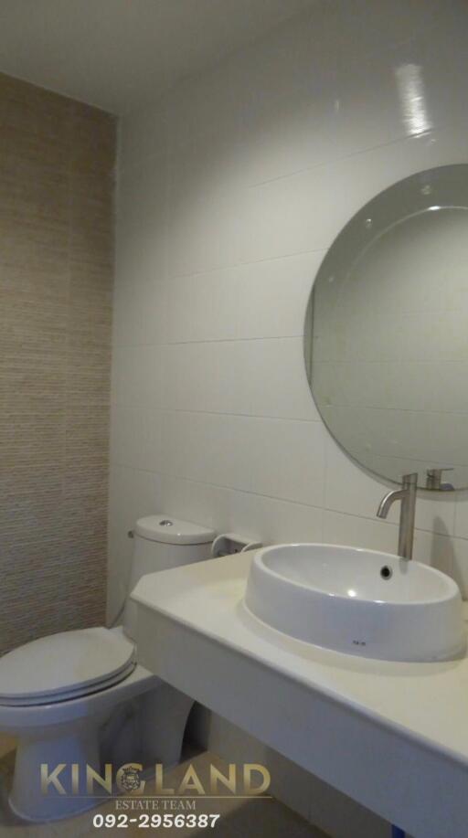 Modern bathroom with round mirror and sink