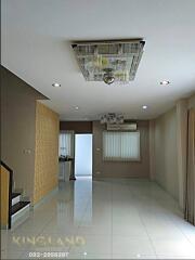 Living room with modern ceiling light, tiled floor, and stairs