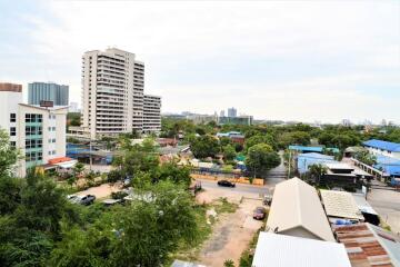 Cityscape view from above with buildings and greenery