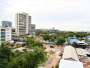 Cityscape view from above with buildings and greenery