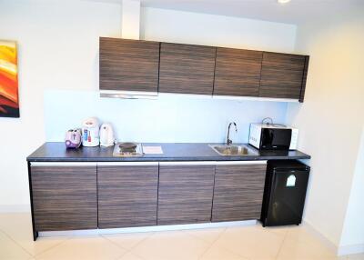 Modern kitchen with dark wood cabinets and appliances