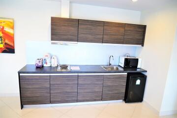 Modern kitchen with dark wood cabinets and appliances