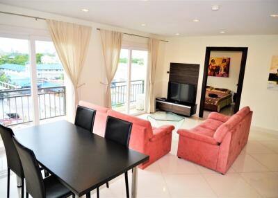 Spacious living room with dining area and large windows