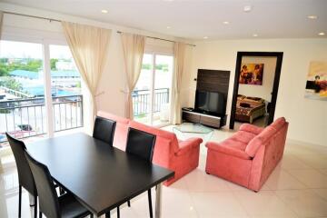 Spacious living room with dining area and large windows