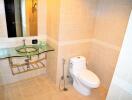 Modern bathroom with glass sink and toilet