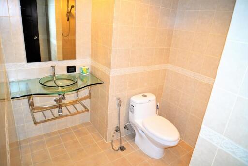 Modern bathroom with glass sink and toilet