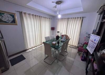 Modern dining room with glass table and white chairs