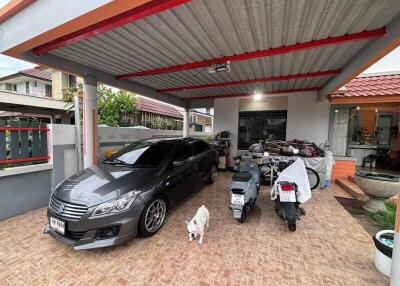 Covered carport with car and motorcycles