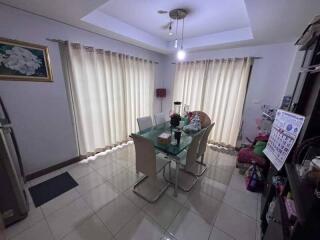 A well-lit dining room with a glass table and chairs