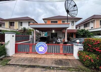 Front view of a residential property with driveway and satellite dish