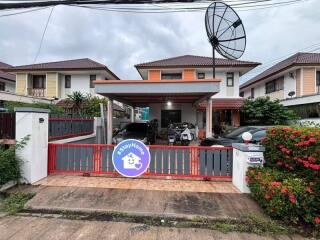 Front view of a residential property with driveway and satellite dish