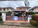 Front view of a residential property with driveway and satellite dish