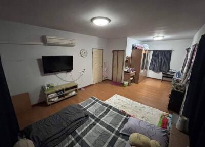 A spacious bedroom with various furnishings