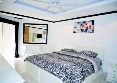 Modern bedroom with patterned bedding and a large mirror