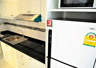 Modern kitchen with white cabinets and black countertop