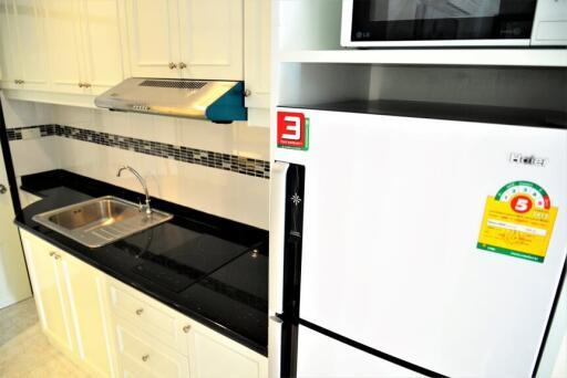 Modern kitchen with white cabinets and black countertop