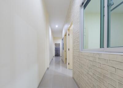 Bright hallway with brick accent wall and modern fixtures