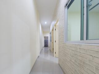 Bright hallway with brick accent wall and modern fixtures