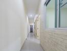 Bright hallway with brick accent wall and modern fixtures