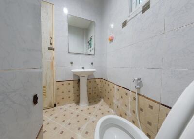 Bathroom with a sink, toilet, and mirror