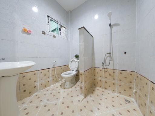 Modern spacious bathroom with toilet and shower area