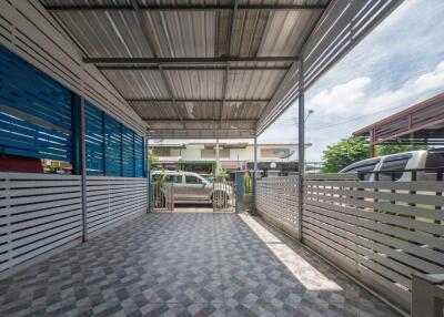 Covered carport with tiled flooring