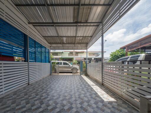 Covered carport with tiled flooring