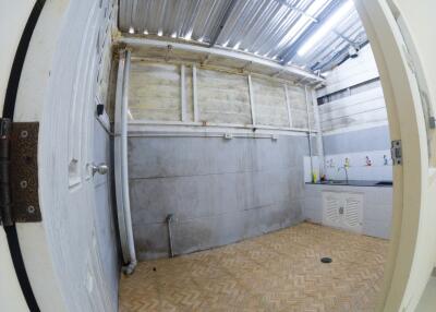 Image of a laundry area with tiled floor and exposed ceilings