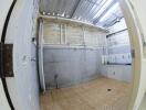 Image of a laundry area with tiled floor and exposed ceilings