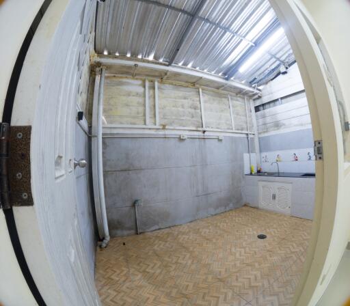 Image of a laundry area with tiled floor and exposed ceilings