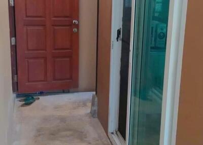 Main entrance with sliding glass door and wooden door