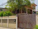 Front view of a house with a gated entrance