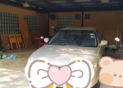 Garage with a parked car and miscellaneous items