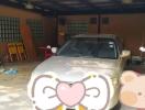 Garage with a parked car and miscellaneous items