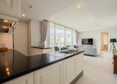 Modern open-concept kitchen and living room with city view