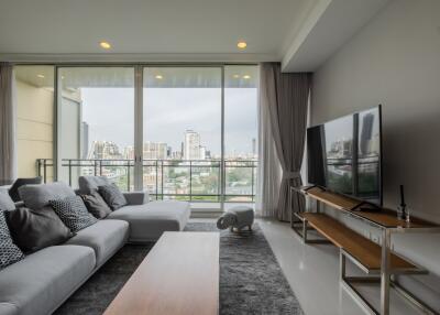 Spacious living room with large windows and city view